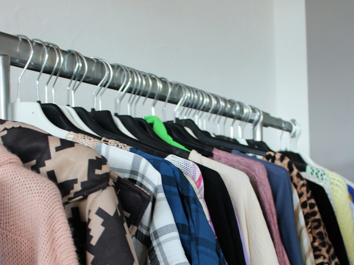 A rail of clothing on hangers